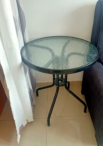Small round glass-top side table with metal frame