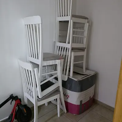 Set of 6 White Wooden Dining Chairs with Cushioned Seats and dinning table.