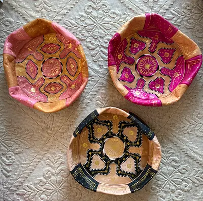 handmade Moroccan leather poufs featuring intricate embroidery and gold accents
