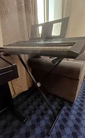 Yamaha PSR-E463 keyboard along with the adapter and stand