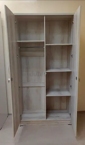 Two-door wooden wardrobe in light oak finish - good condition