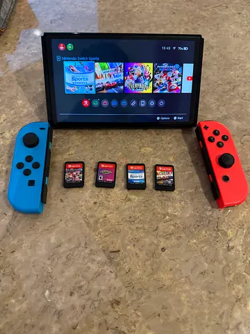 Nintendo Switch with Joy‑Cons and optional 4 Game Cartridges - Working Condition