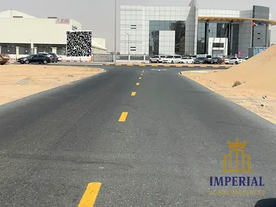 Residential and commercial plot (G+8) for sale in Al Jarf Industrial Area 3, near the Ajman Driving Academy