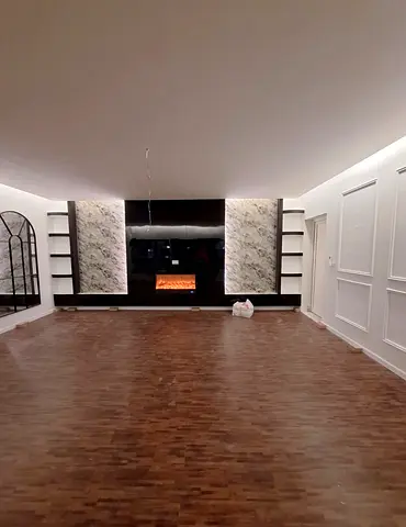 Large modern entertainment wall unit with built-in shelves and electric fireplace