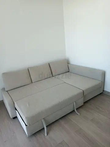Light grey L-shaped sofa bed with storage — good condition