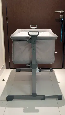 Gray bedside bassinet / co-sleeper - adjustable height, gently used