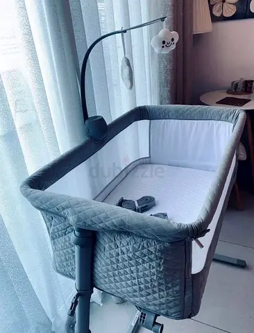 Grey bedside bassinet / cradle with mobile - good condition