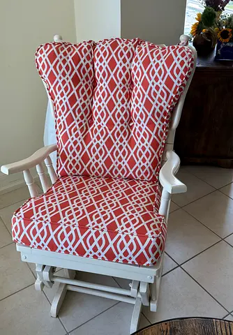 White Sliding Wooden Glider Rocker with Coral Geometric Cushions
