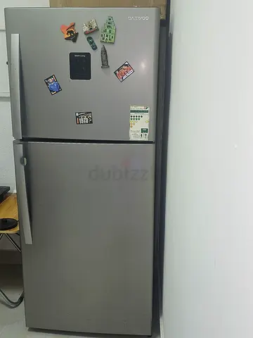 Silver double-door refrigerator with top freezer - good working condition