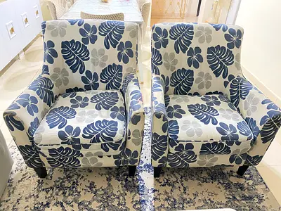 Pair of floral pattern armchairs with cover