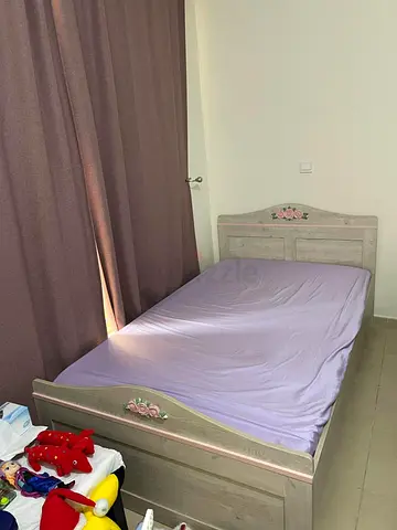 Single wooden bed with floral headboard – good condition
