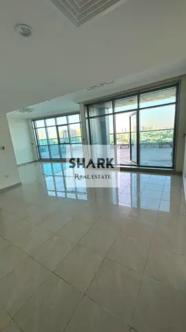 Two-bedroom apartment with a living room in Corniche Residence towers, city view.