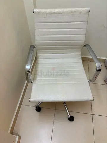 White swivel  chair with chrome arms and wheels