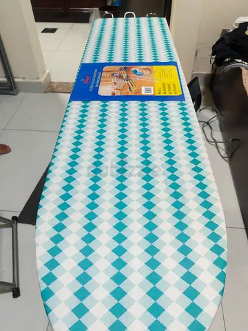 Ironing board in brand new — adjustable height, cover included - stain free and absolutely new