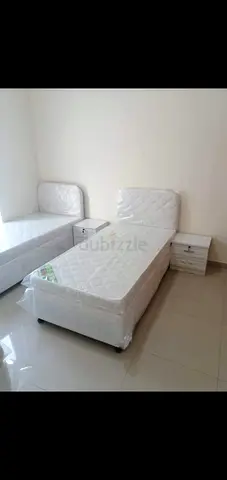 Two single beds with mattresses and bedside tables - good condition
