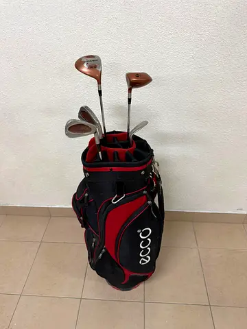 A complete set of golf clubs with a carrying case.