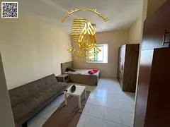 Spacious studio apartment for annual rent, unfurnished, in Al Rashidiya 3, with a separate kitchen.