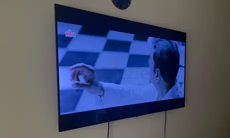 Kougan 58-inch LED Smart HDR TV mounted on wall - working condition