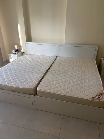 White wooden double bed frame with two single mattresses (split) - good condition