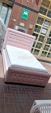Single pink upholstered bed with mattress - good condition