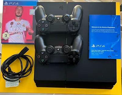PlayStation 4 Fat with 2 DualShock 4 Controllers, FIFA20 and Cables - Good Condition