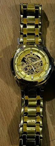 Gold-tone skeleton mechanical womens wristwatch with metal bracelet