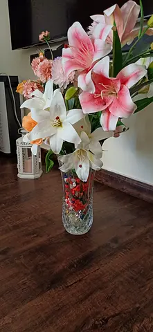 Decorative glass vase with artificial lilies and mixed flowers
