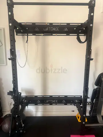 Wall mounted folding half rack and gym flooring