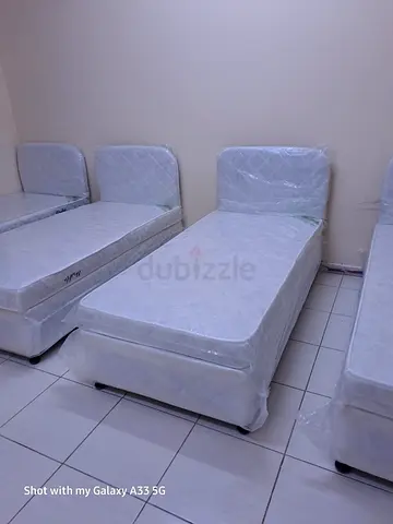 Two single beds with mattresses and bedside tables - good condition