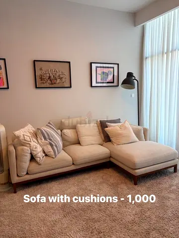 Beige L-shaped Sofa with Cushions (Good Condition) - AED 1,000
