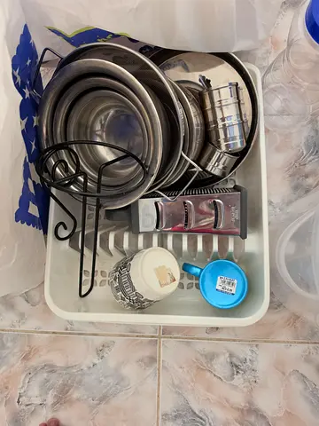 Used kitchen utensil set with dish rack and stainless steel bowls