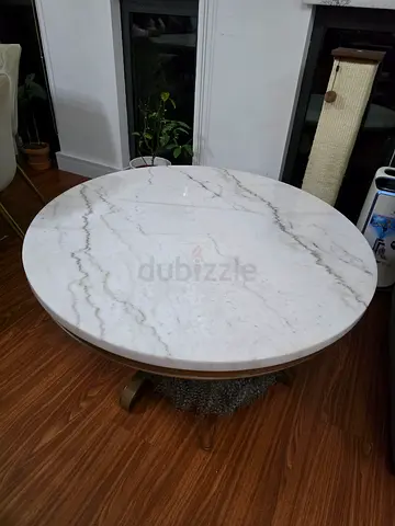 solid circle marble coffee table with one broken leg which can be fixed.