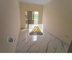 For rent – apartment in Al Muwaihat 3: master bedroom and living room with balcony, central AC, 2 