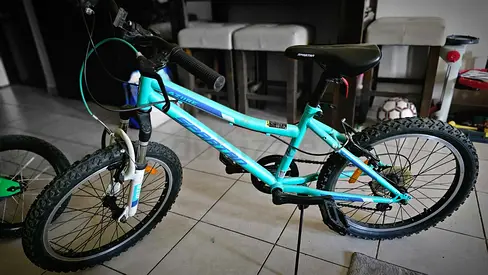 Used turquoise 20-inch mountain bike — good condition