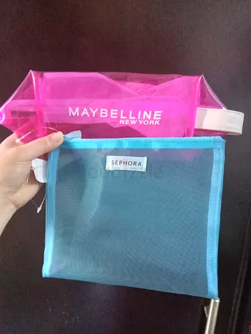 Two small cosmetic pouches (Maybelline clear pink + Sephora mesh blue)