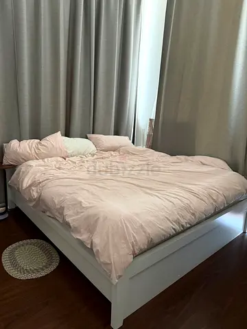 White wooden double bed frame with storage base