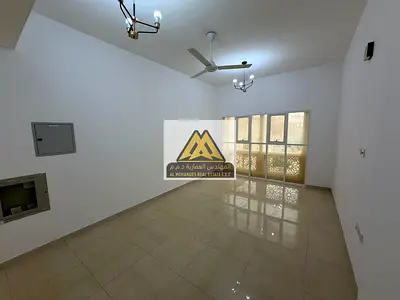 A one-bedroom apartment for annual rent in Al Muwaihat 3, Ajman, featuring spacious areas and a practical design with a separate living room, two bath