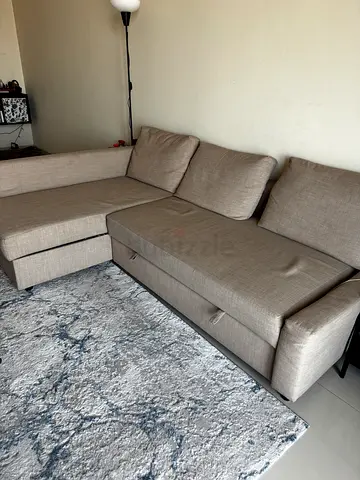 Light grey L-shaped sofa cum bed with storage, good condition