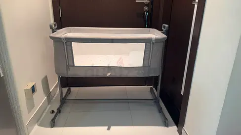 Gray bedside bassinet / co-sleeper - adjustable height, gently used