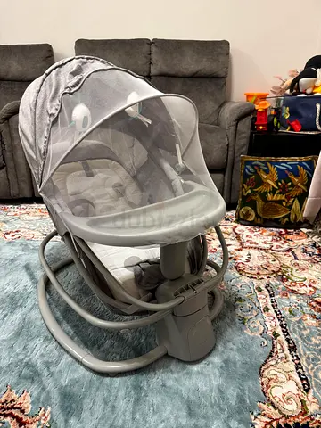 Mastela 4-in-1 Baby Swing and Rocker in grey with music, feeding tray and mosquito net.