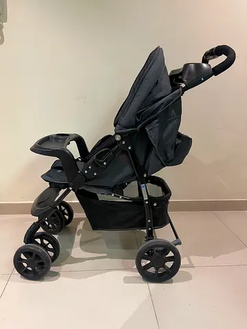 Juniors Well-kept black and grey baby stroller/pram - folds, storage basket included