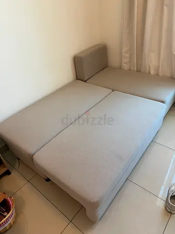 Light beige 2-seater sofa bed in good condition