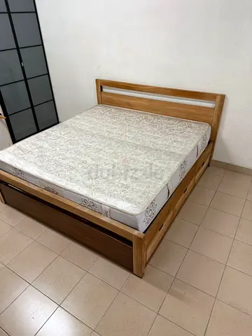Natural wood bed with a modern design and built-in storage drawers