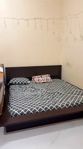 Low-profile wooden double bed frame with headboard