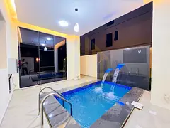 A stunning villa with a swimming pool, featuring 6 master bedrooms with built-in wardrobes and a dec