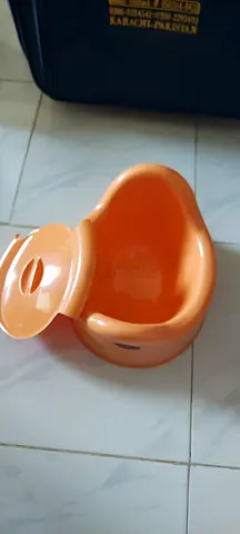 Lightly used orange baby potty seat — easy clean, compact