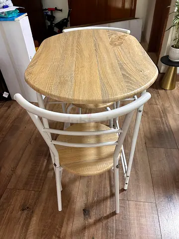 Small round wooden table and two chairs with white metal legs - good condition.