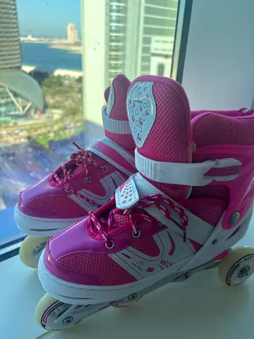 Pink adjustable inline roller skates, kids size