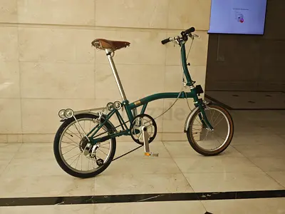 Green folding commuter bike with 16-inch wheels