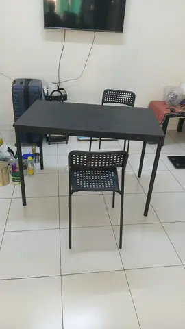 Simple black dining/office table with four chairs